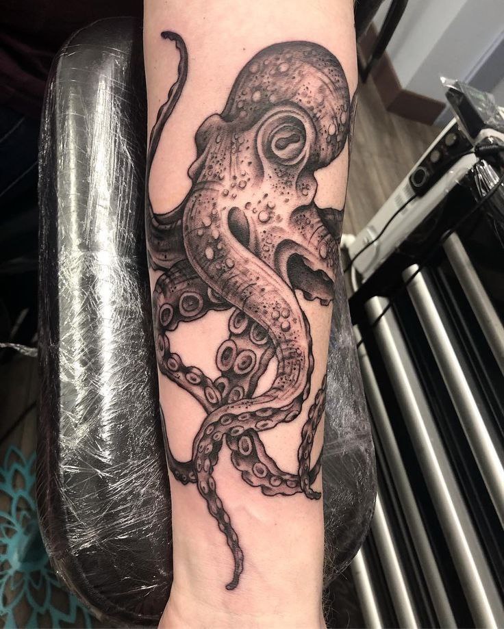 Large octopus tattoo on the forearm for men