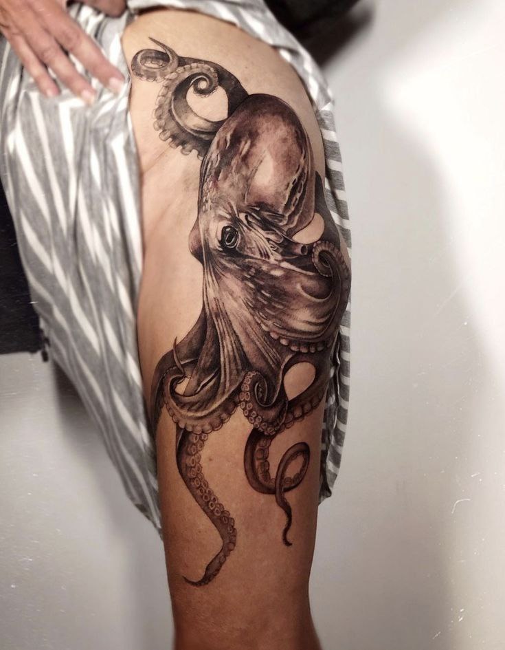 Large octopus tattoo on the thigh for women