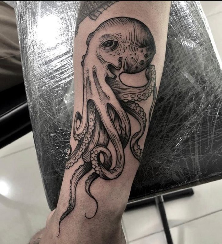 Large octopus tattoo on the forearm for men