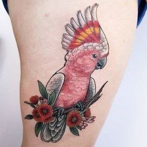 Colorful parrot tattoo with flowers on the thigh for women