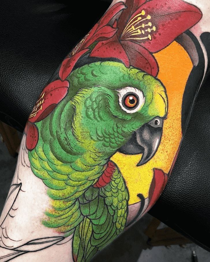 Colored parrot tattoo on the shin for men