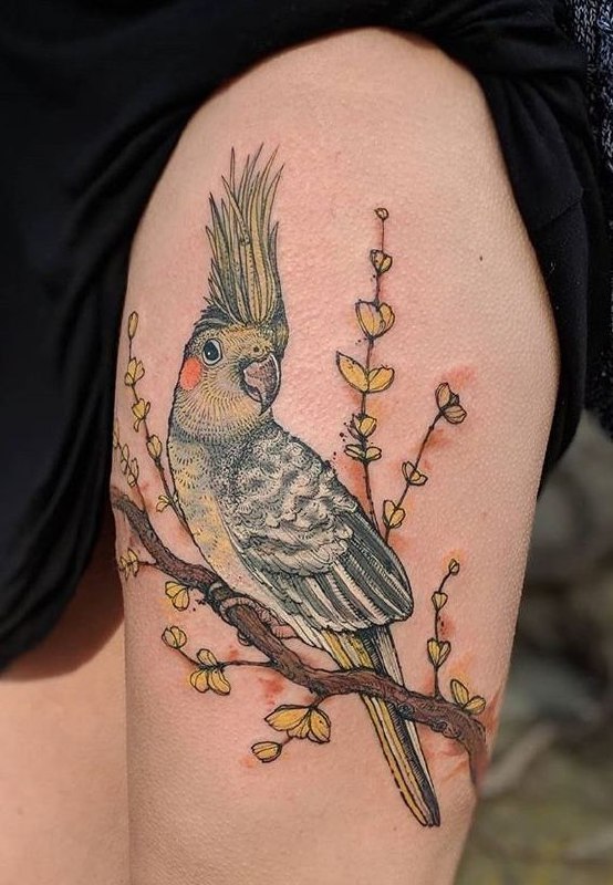 Large parrot tattoo on the thigh for women