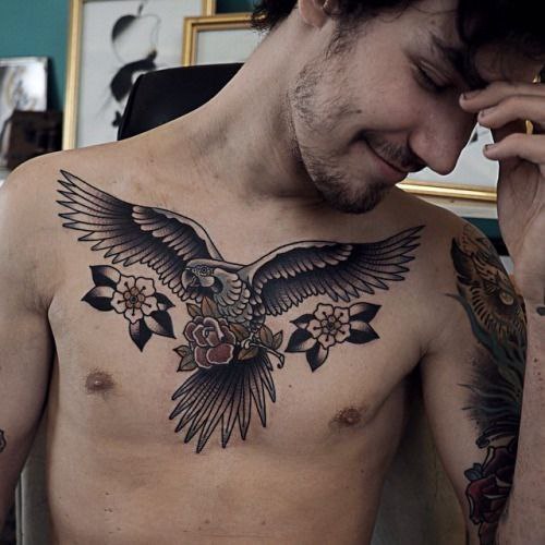 Large parrot and flower tattoo on the chest for men