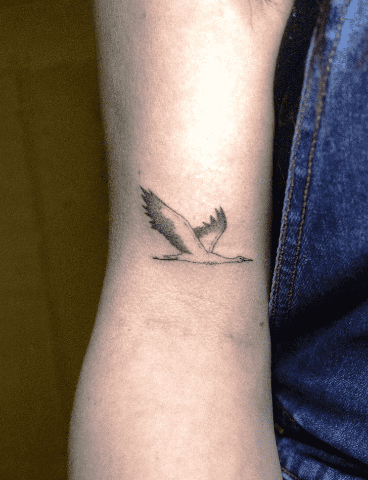 Small stork tattoo on the shoulder for women