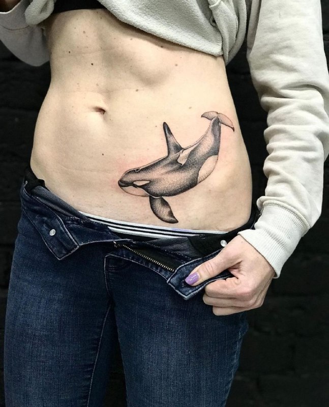 Large orca tattoo on the abdomen for women