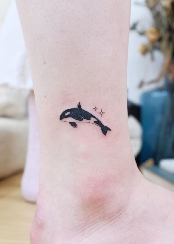 Orca tattoo on the shin for women