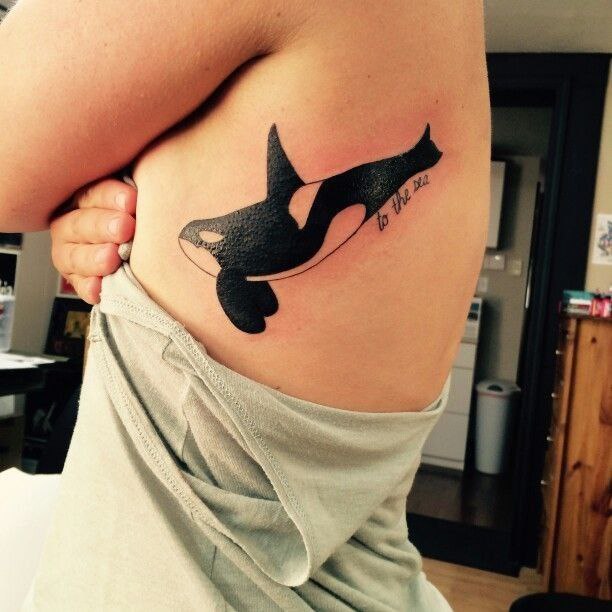 Large orca tattoo on the side for women