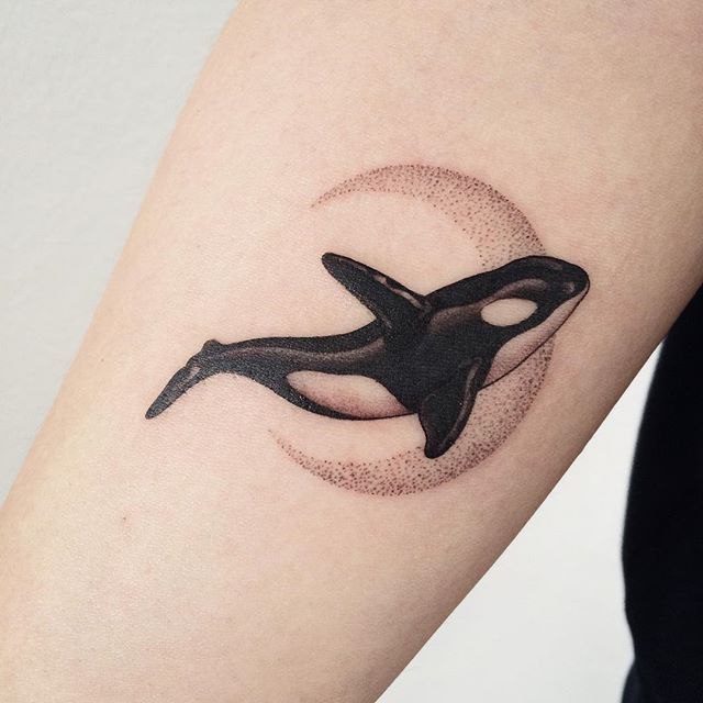 Orca tattoo on the arm for women