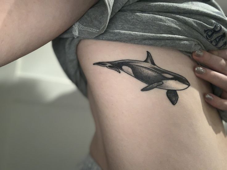 Orca tattoo on the side for women