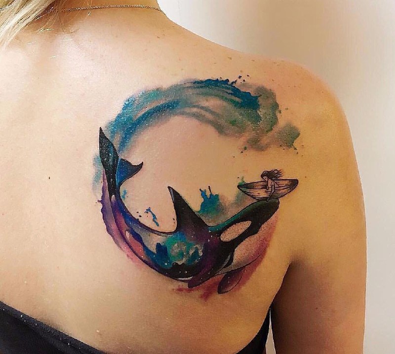 Colored orca tattoo on the shoulder blade for women