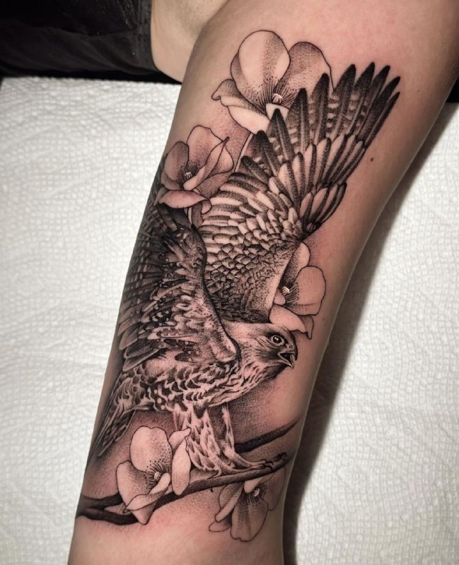 Large falcon and flower tattoo on the shin for men