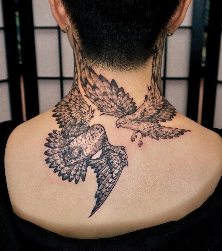 Large tattoo of two falcons on the neck for women