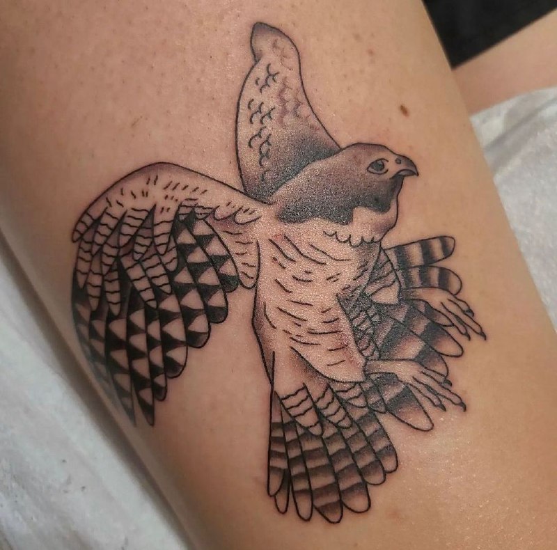 Falcon tattoo on the thigh for men