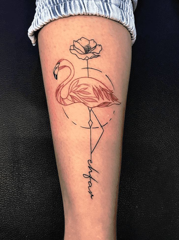 Flamingo tattoo with an inscription on the calf for women