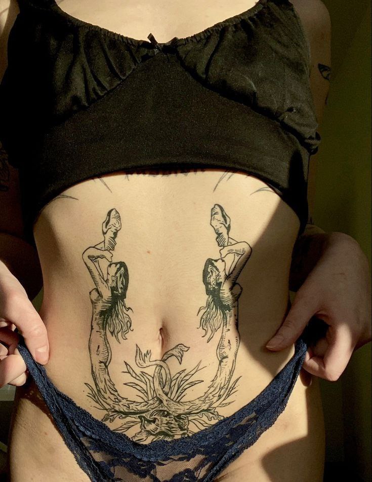 Large tattoo on the abdomen for women