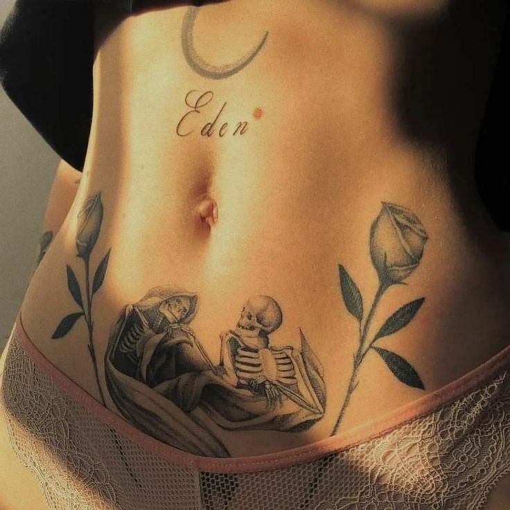 Tattoo of two skeletons on the stomach for women