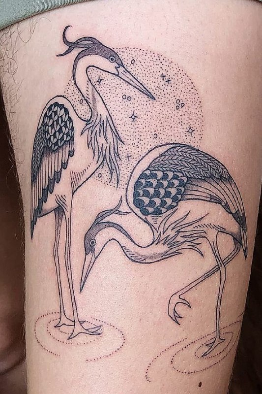 Large tattoo of two storks on the thigh for men