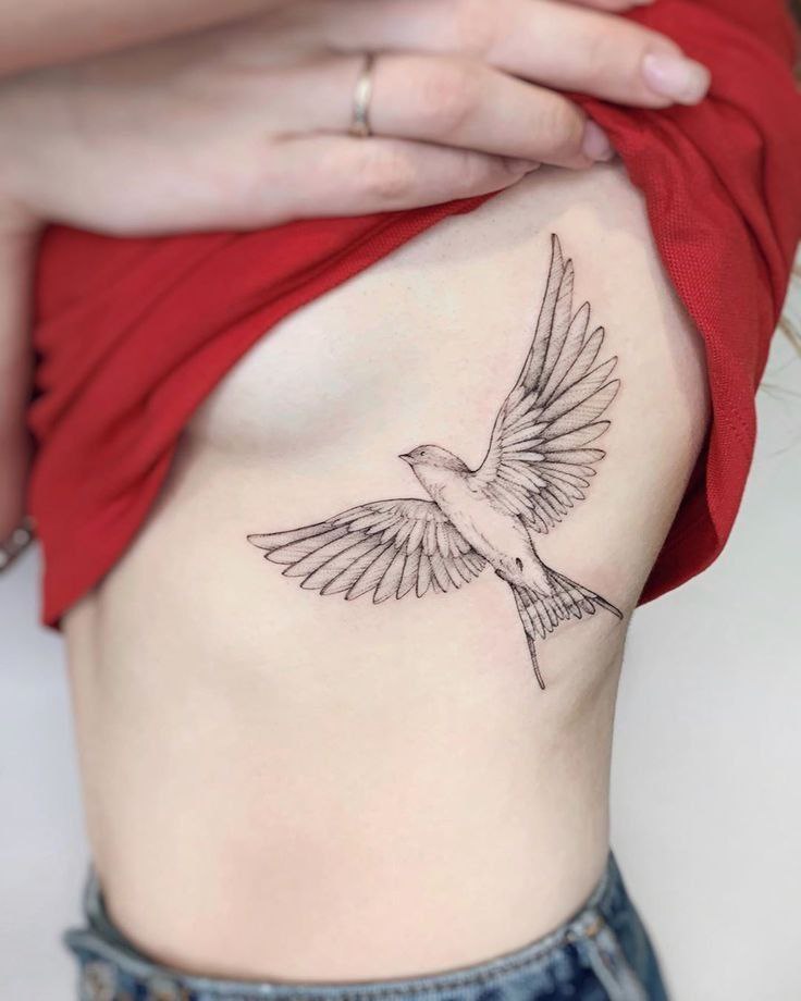 Large swallow tattoo on the side for women