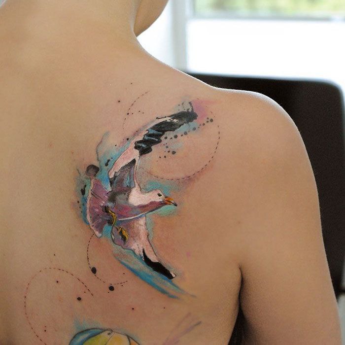 Color tattoo of seagulls on the shoulder blade for women Color tattoo of seagulls on the shoulder blade for women