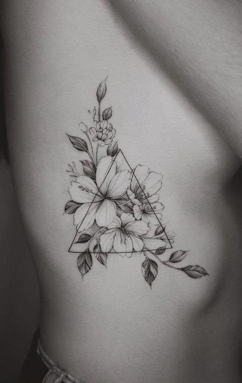 Tattoo of flowers in a triangle on the side for women