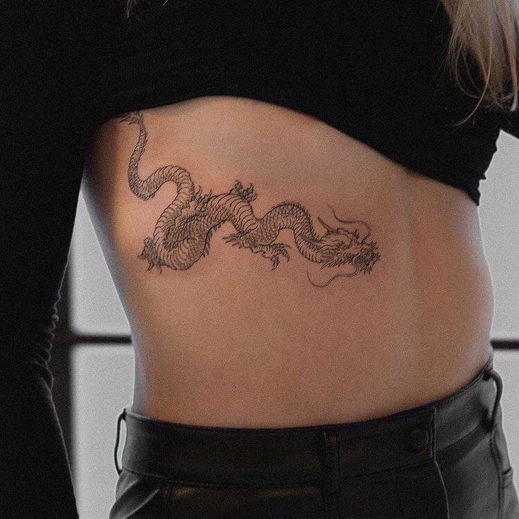 Large dragon tattoo on the side for women