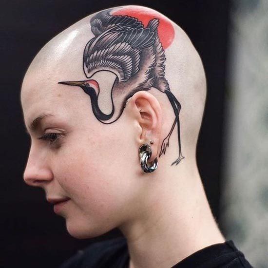 Large crane tattoo on the head for women