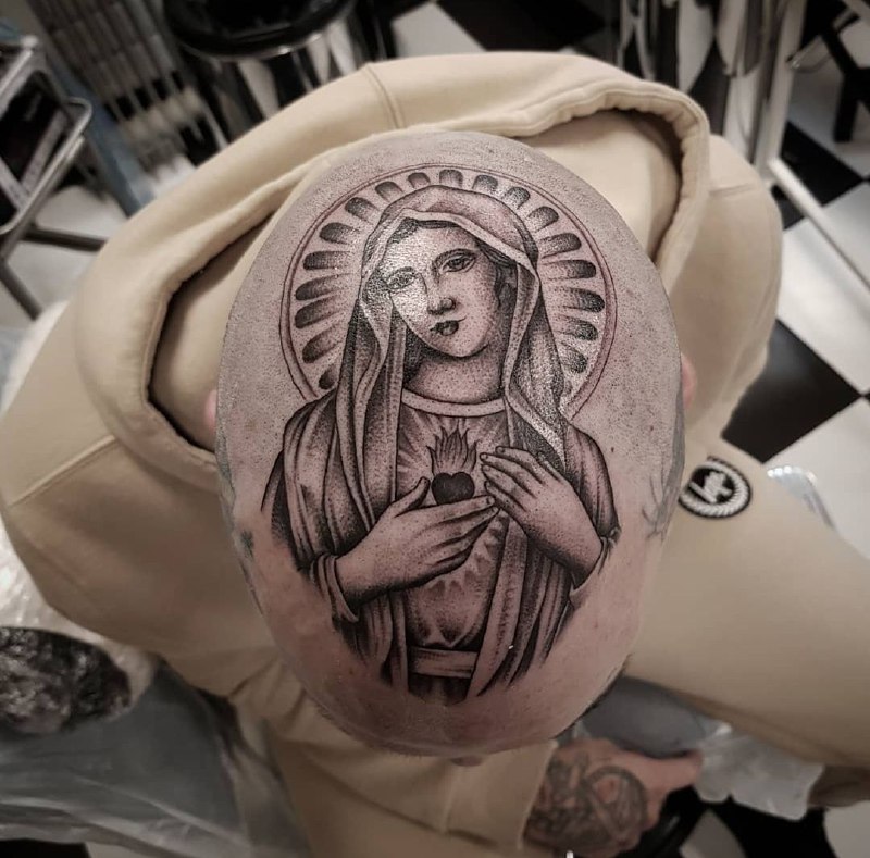 Large tattoo of the Mother of God on the head for men