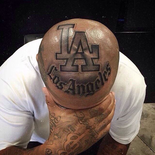 Large tattoo with inscription on the head for men