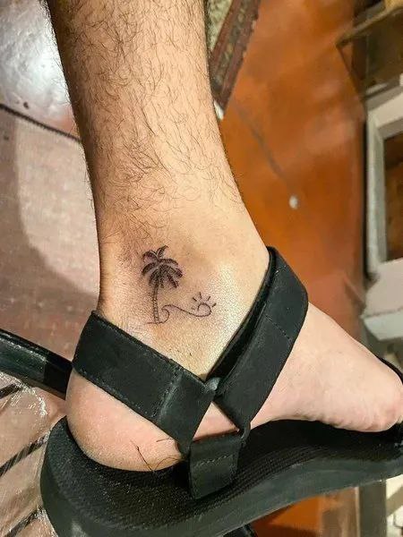 Small palmi tattoo on the ankle for men