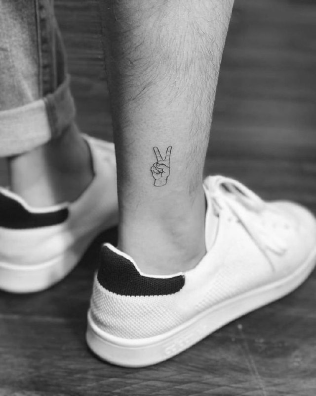 Small hand tattoo on the ankle for men