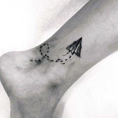 Tattoo of a paper airplane on an ankle for men