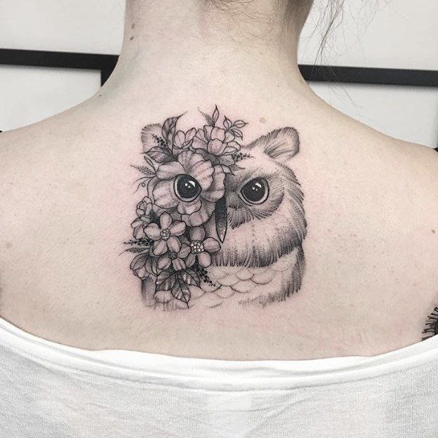 Large owl tattoo on the back for women