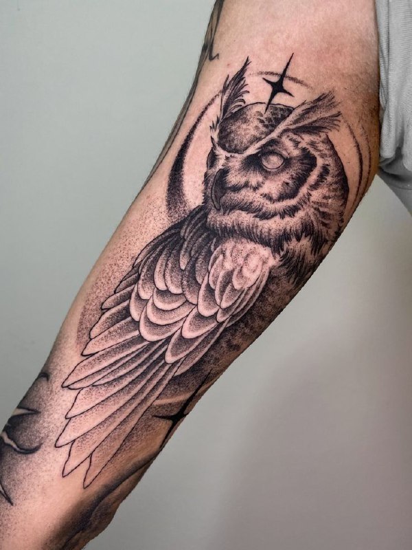 Large owl tattoo on the arm for men