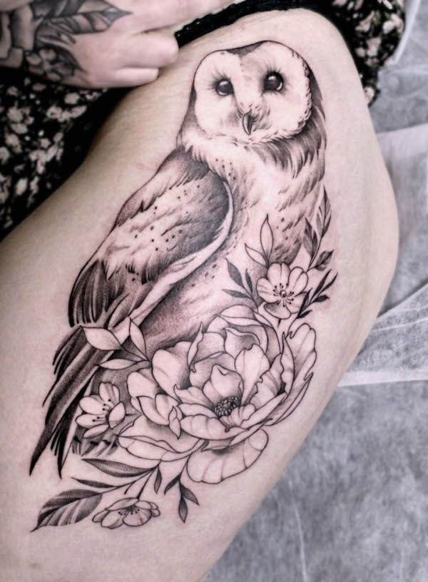 Large owl and flowers tattoo on the thigh for women