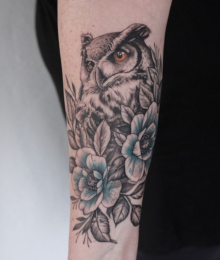 Large owl tattoo on the arm for women