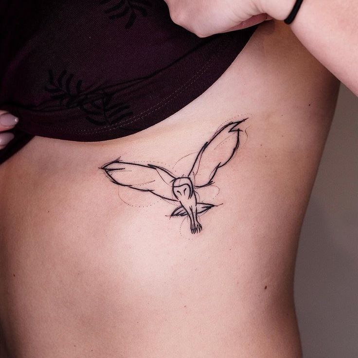 Small owl tattoo on the stomach for women