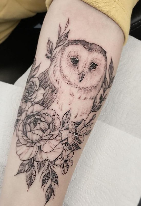 Large owl and flowers tattoo on the forearm for women