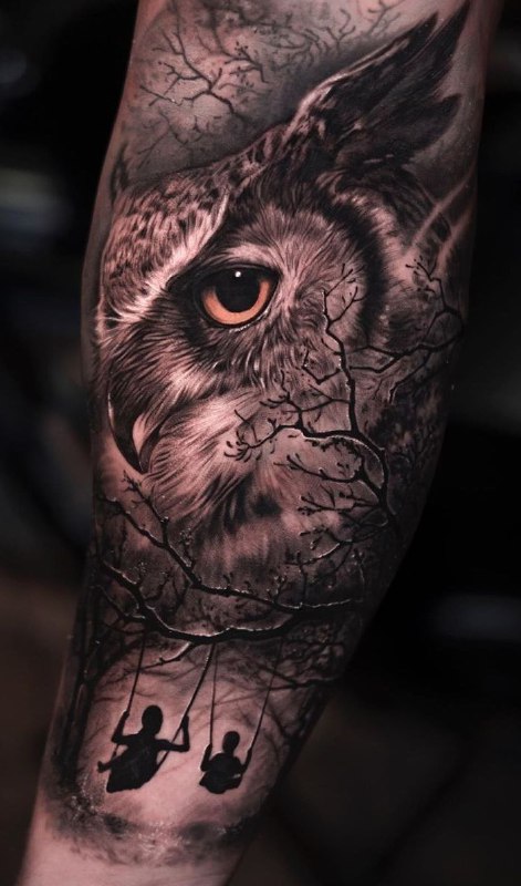 Large owl tattoo on the arm for men