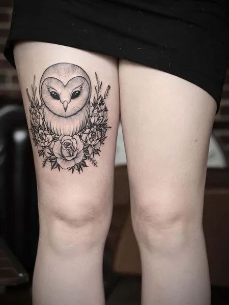 Large owl and flowers tattoo on the thigh for women