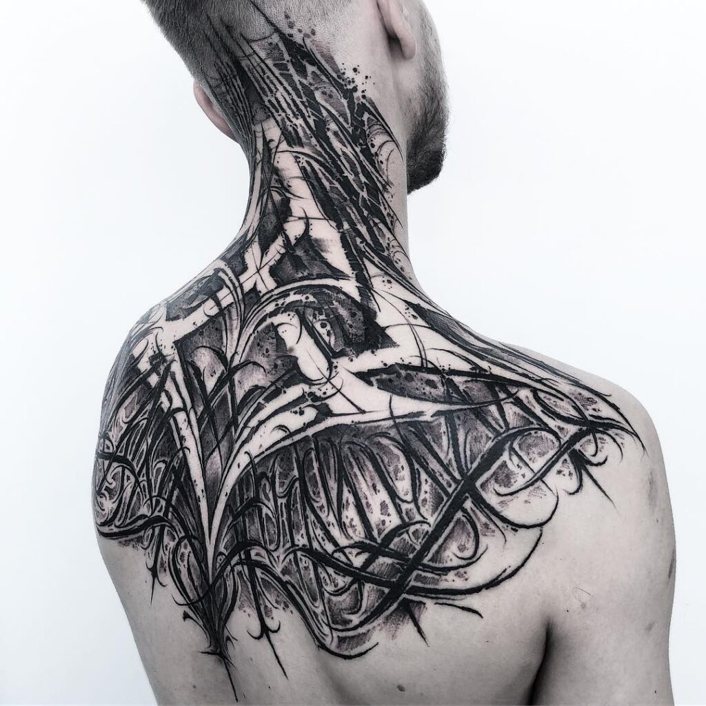 Calligraphy style tattoo on the back for men