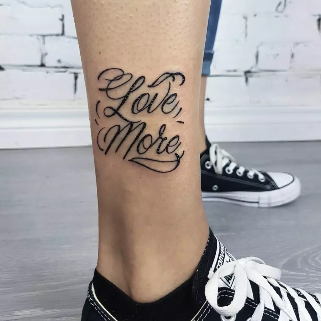 Calligraphy style tattoo on the lower leg for wom