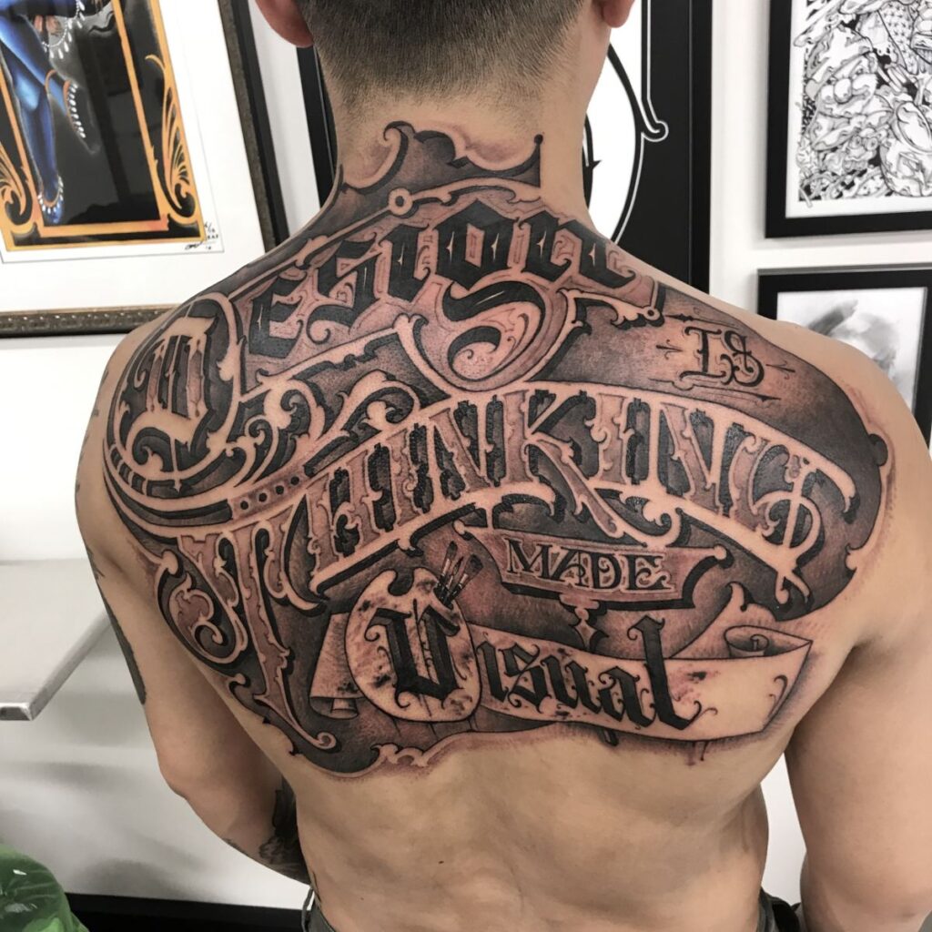 Calligraphy style tattoo on the back for men