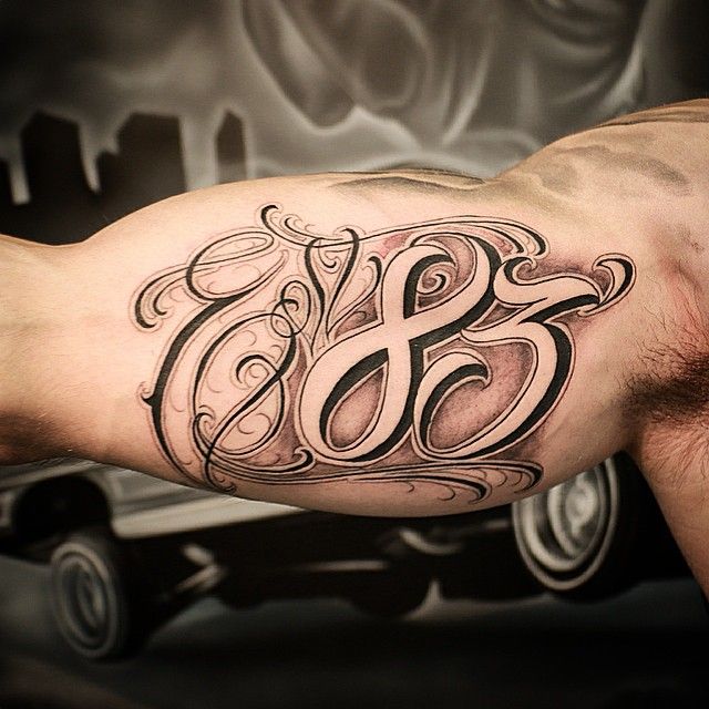 Calligraphy style tattoo on the bicep for men