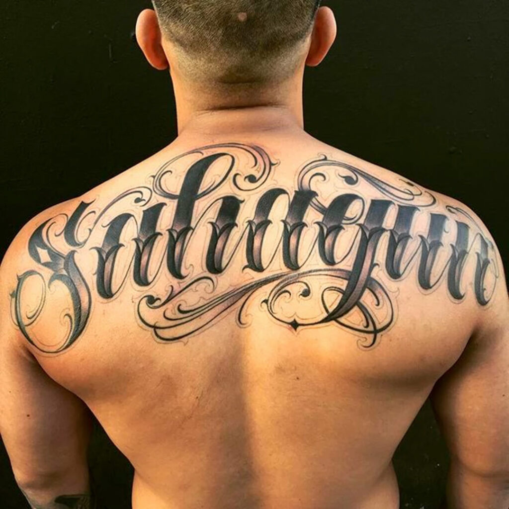 Calligraphy style tattoo on the back for men