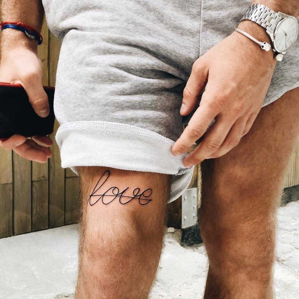 Tattoo with an inscription on the knee for men