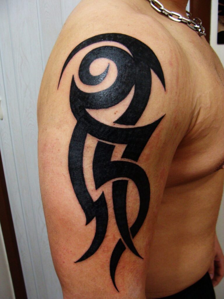 Large celtic style tattoo on the shoulder for men