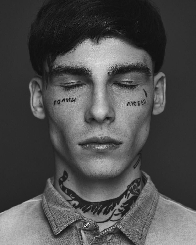 Tattoo with inscription on the face for men