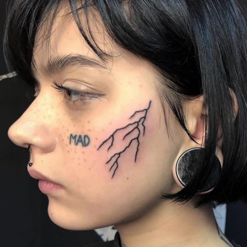 Lightning tattoo on the face for women