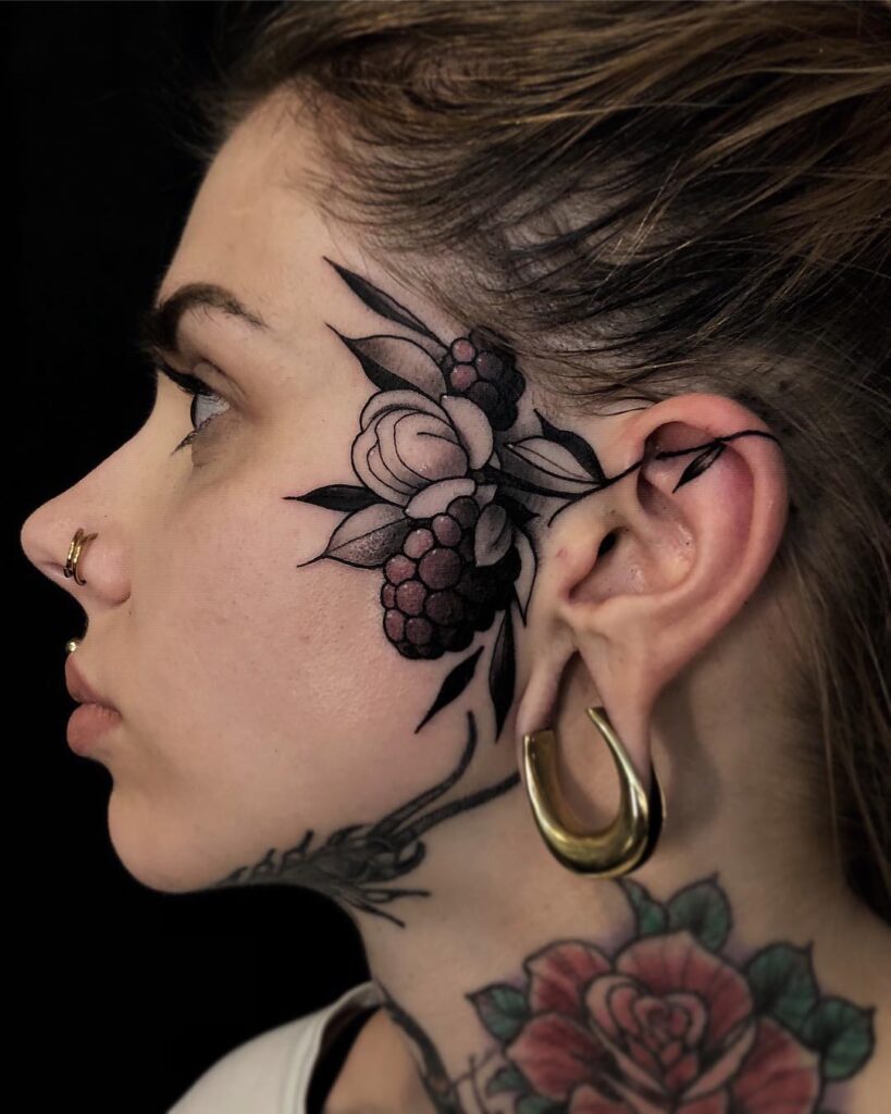 Tattoo of berries on the face for women