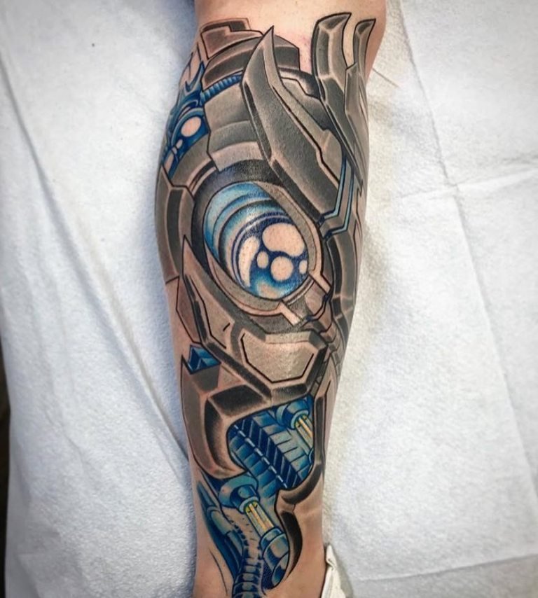 Colored tattoo in the style of biomechanics on the shin for men